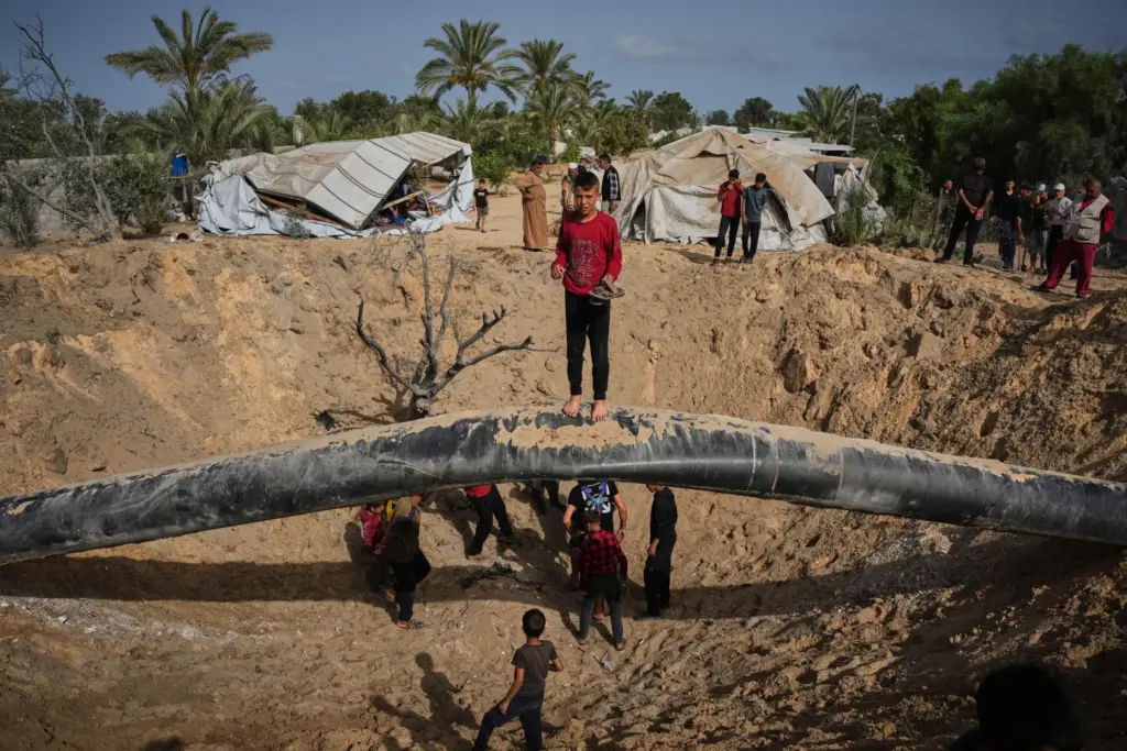 Palestinians inspect the destruction caused by an Israeli strike in Khan Younis.