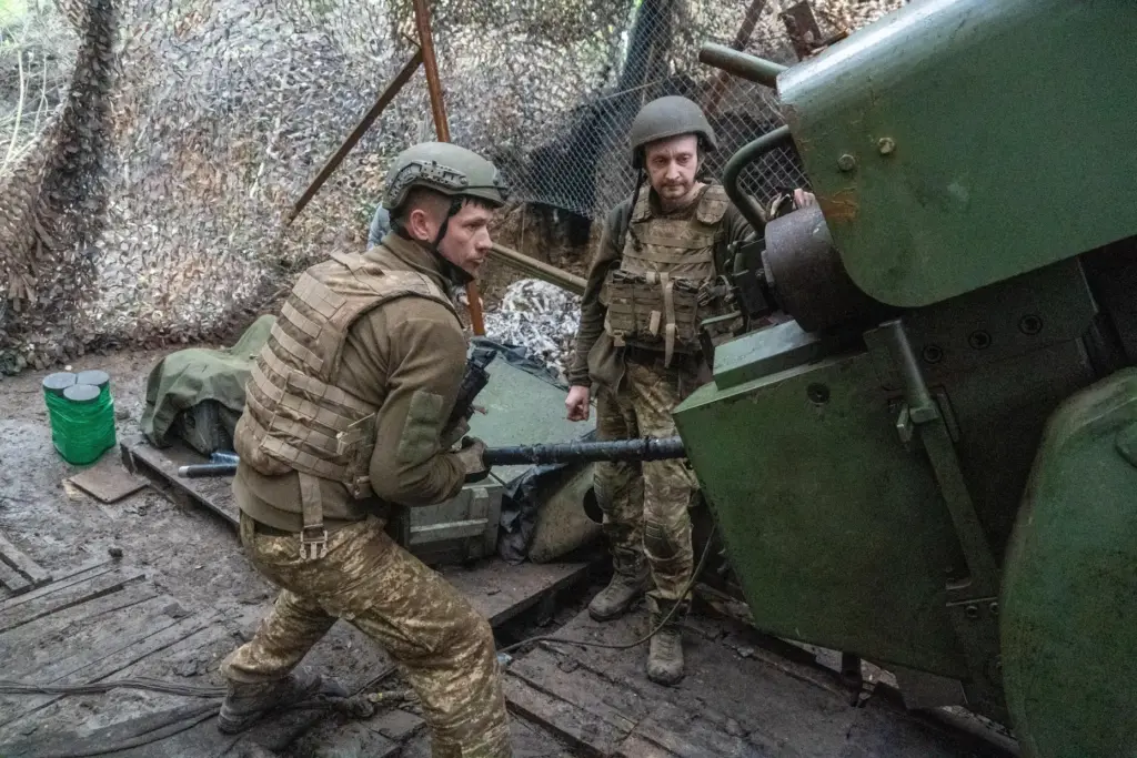Soldiers from Ukraine's Khartia brigade fire a canon towards Russian army positions.