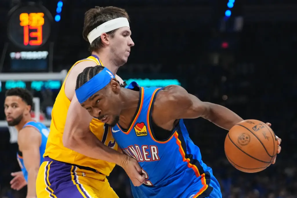 Oklahoma City Thunder guard Shai Gilgeous-Alexander, right, drives to the...