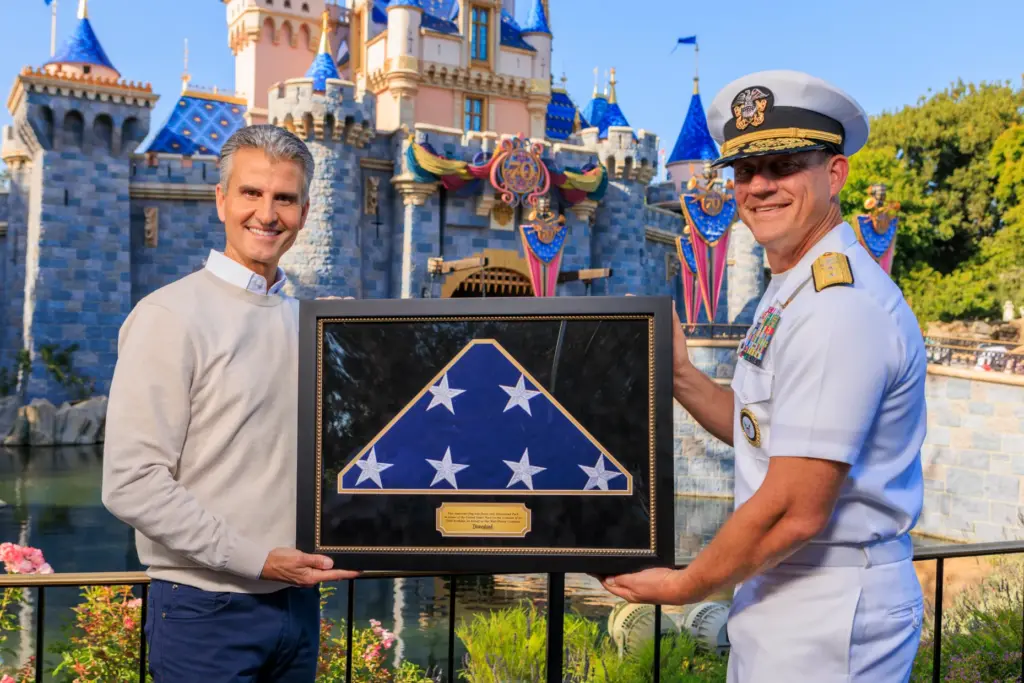 Disney CEO Josh D’Amaro presents Rear Adm. Robert Nowakowski with...