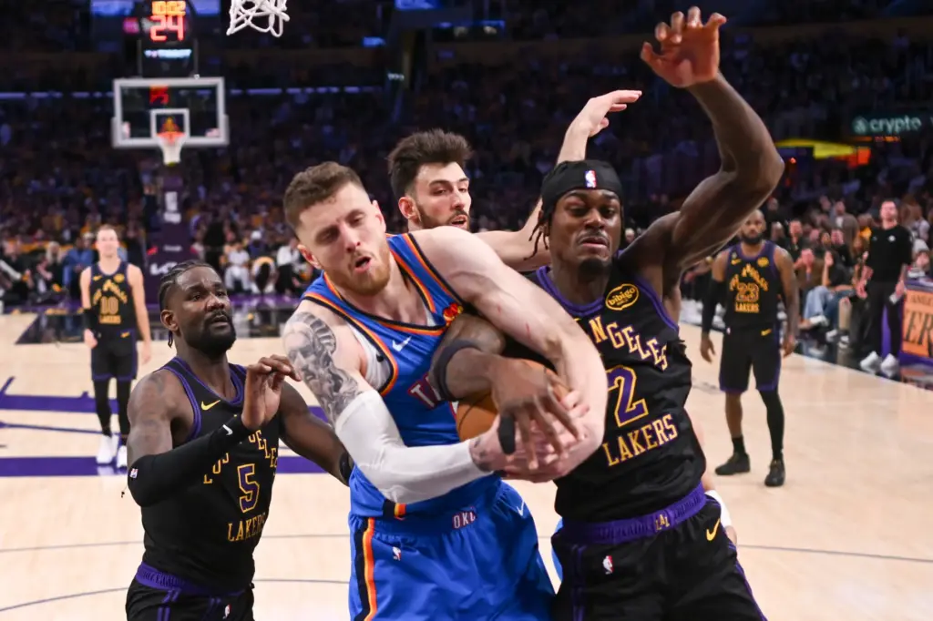 Oklahoma City Thunder center Isaiah Hartenstein, middle, battles Lakers forward...