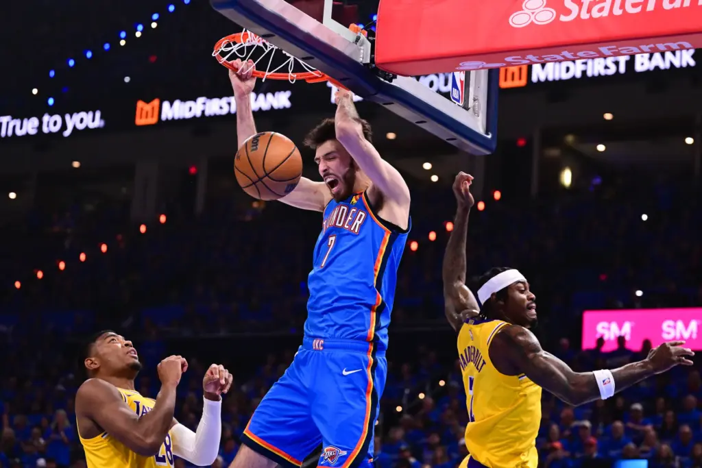 Oklahoma City Thunder forward Chet Holmgren dunks between Lakers forwards...