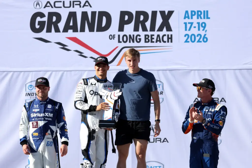 Winning Indycar driver, Alex Palou, center left, poses for a...