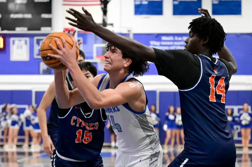 Brennen DeLa Cruz #15 and Emmanuel Igbekoyi #14 of Cypress...