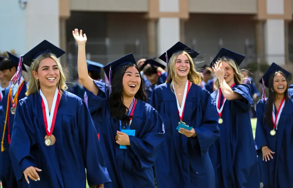 Graduates Sydney Kovac, left, Audrey Kim, Ryann Radine and Lauren...