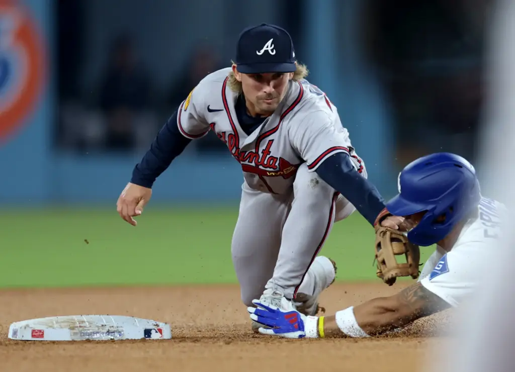 Atlanta Braves shortstop Jim Jarvis tags the Dodgers’ Santiago Espinal...