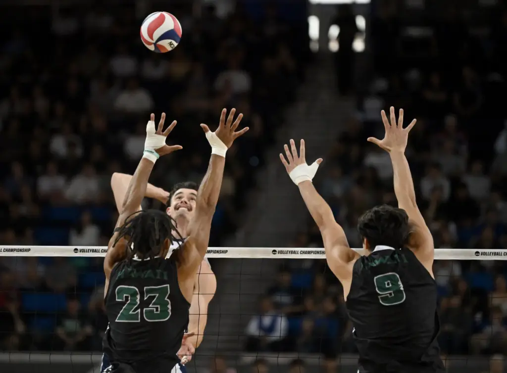 UC Irvineâs William D’Arcy, top left, spikes the ball as...
