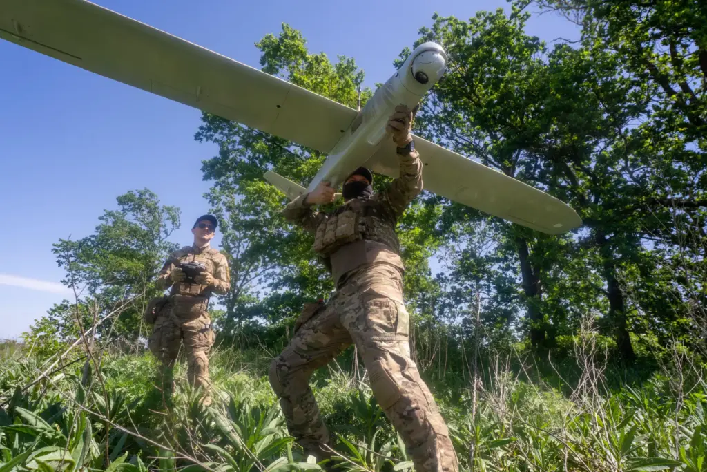 Ukrainian servicemen of the Khartia brigade launch a drone toward Russian positions.