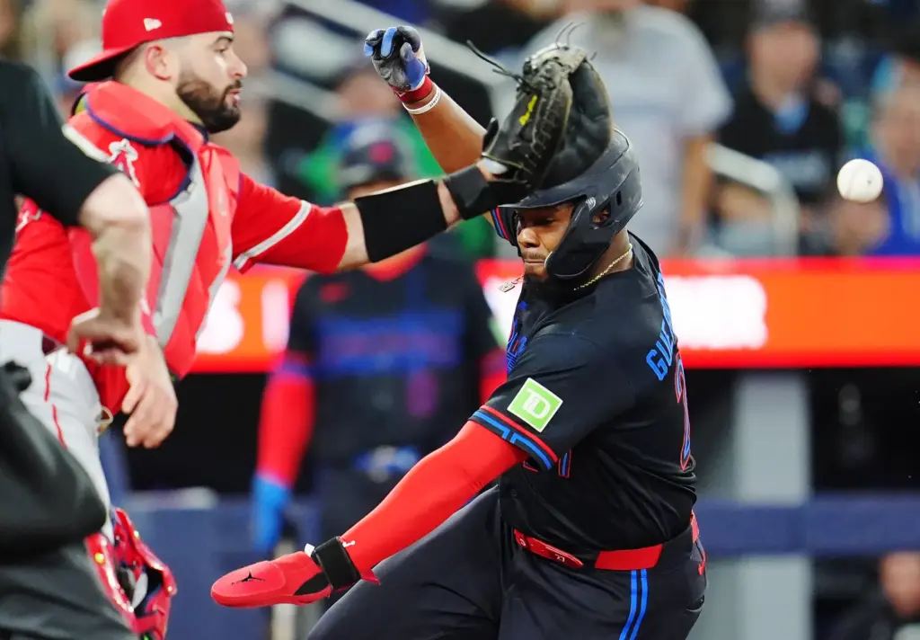 Toronto Blue Jays star Vladimir Guerrero Jr., right, scores as...