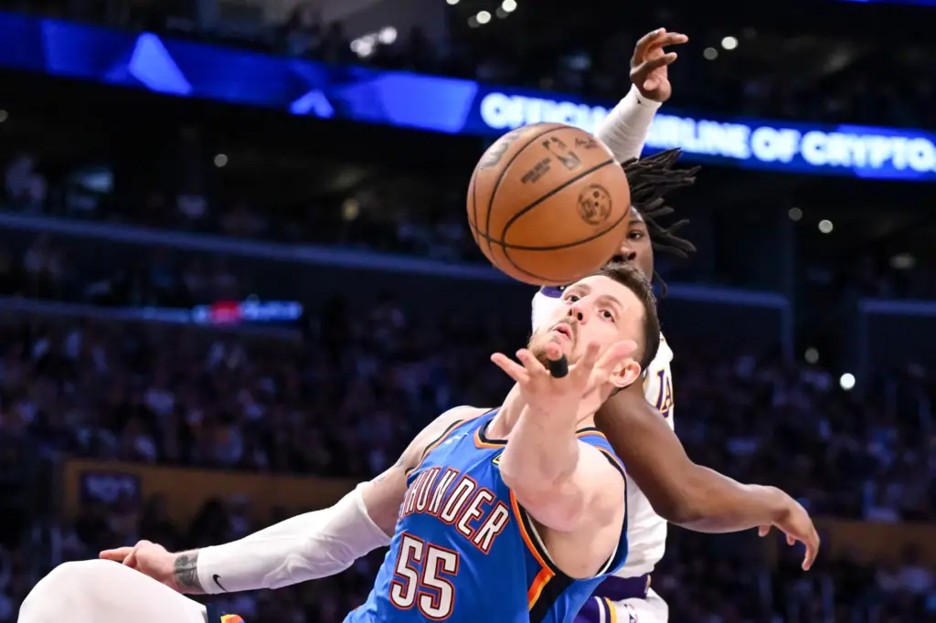 Oklahoma City Thunder center Isaiah Hartenstein, front, and Lakers forward...