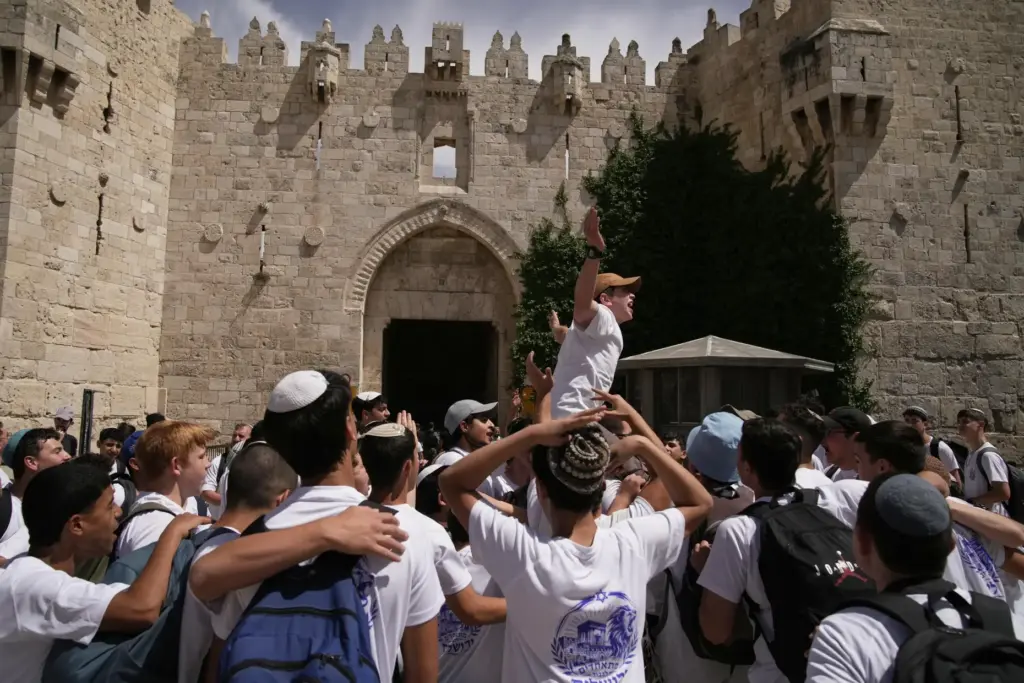 Israeli youth celebrate in Damascus Gate ahead of a march...