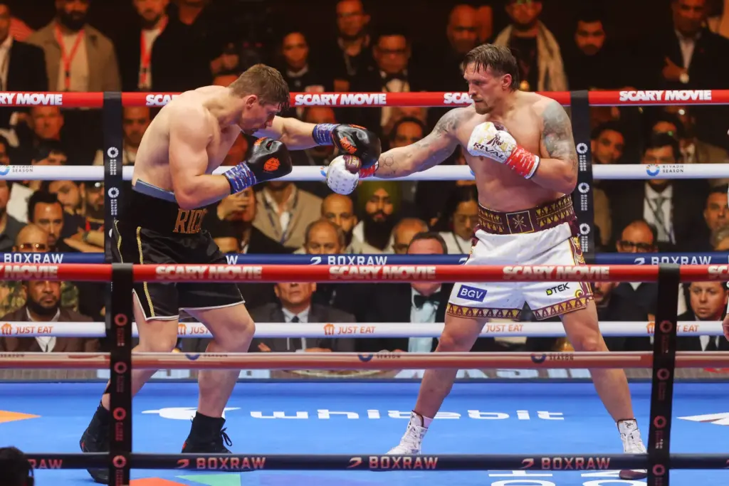 Oleksandr Usyk, right, battles Rico Verhoeven, left, during a boxing...
