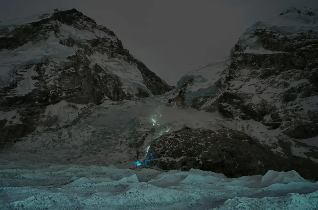 A trail of mountaineers' headlamps is visible from Everest Base Camp.