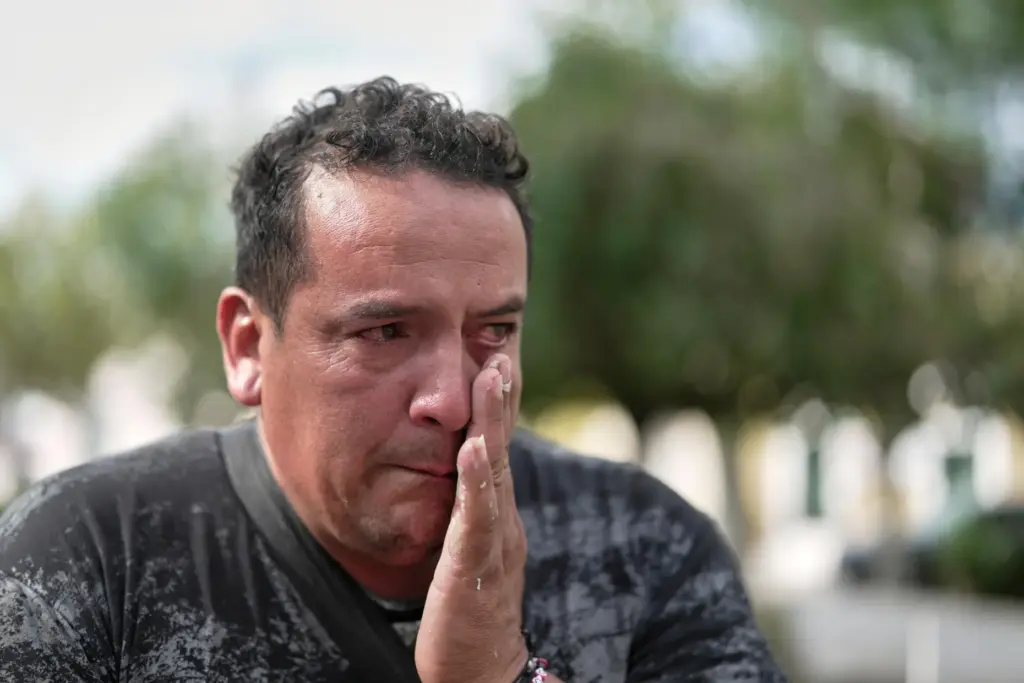 David Delgado cries as he speaks about his son Rodrigo...