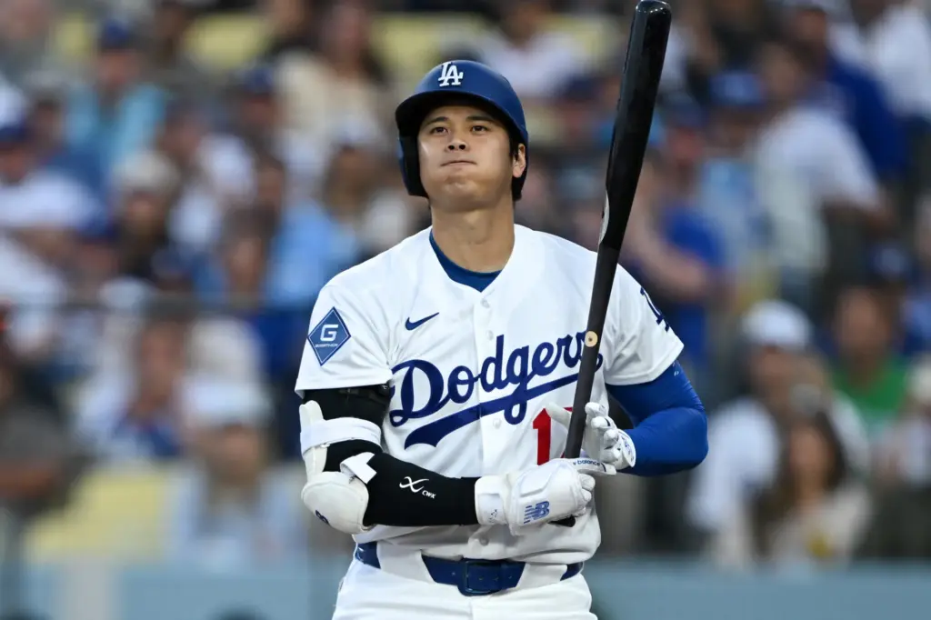Dodgers star Shohei Ohtani reacts after striking out during the...