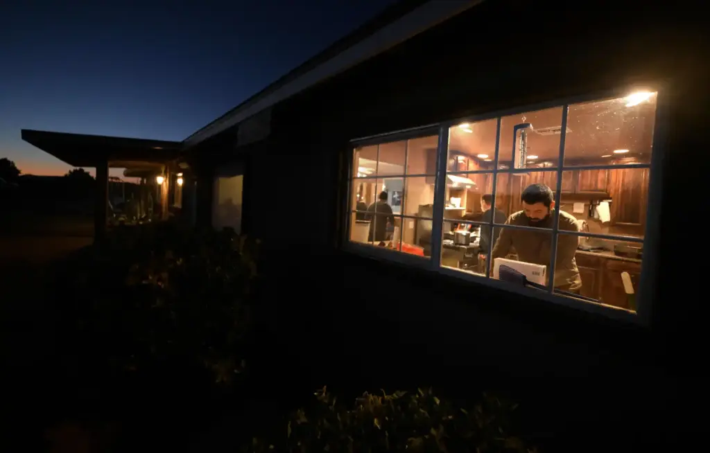 Before sunrise, Rafael Rivera, 33, of Bellflower, prepares sandwiches for...