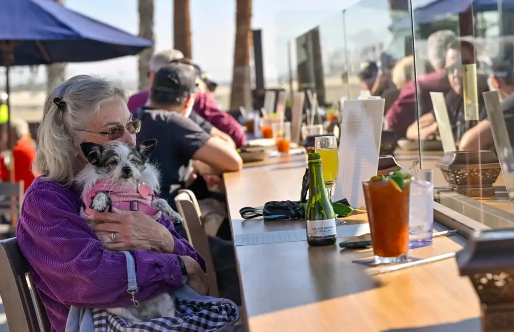 Diana Little holds on to her dog Scruffy as she...