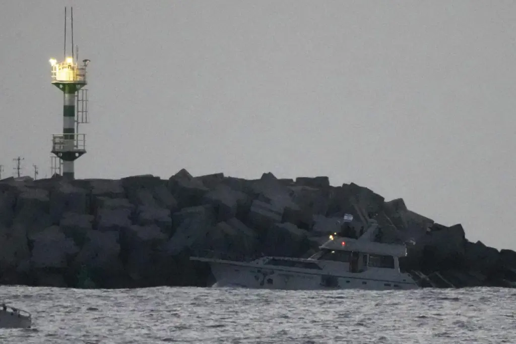 Israeli naval forces sail a confiscated Gaza-bound flotilla boat into Ashdod port.