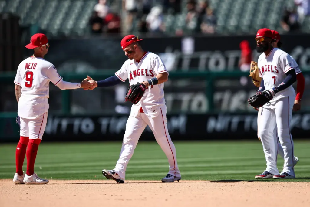 Angels center fielder Mike Trout, middle, and shortstop Zach Neto...