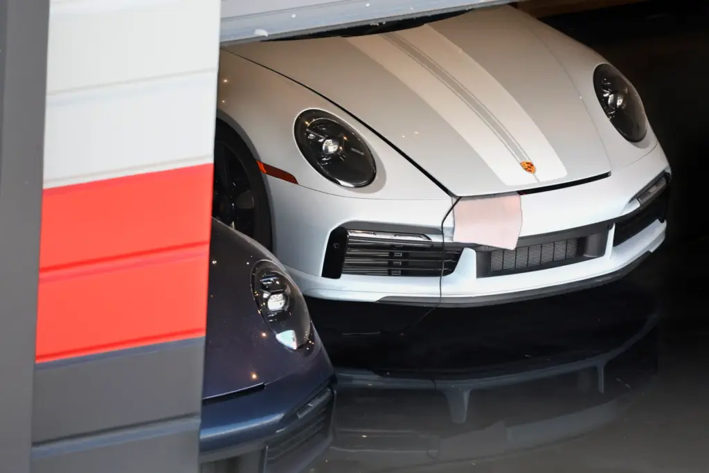 A Ferrari is shown peeking out of an ownerâs unit...