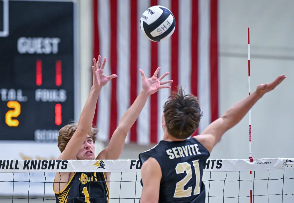 Foothill outside hitter Jonah Van lersel, left, blocks a hit...