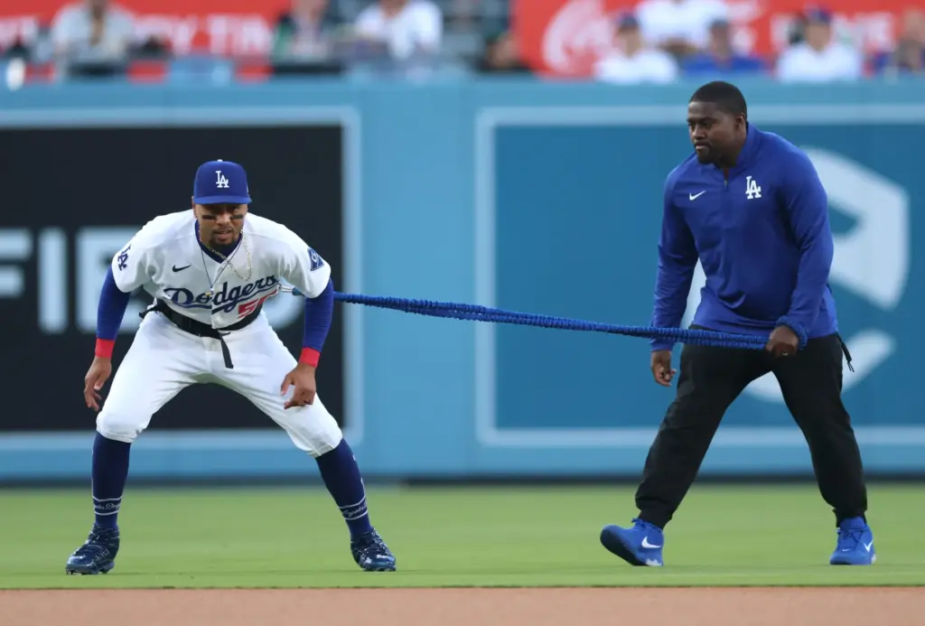 Dodgers shortstop Mookie Betts warms up with Travis Smith before...