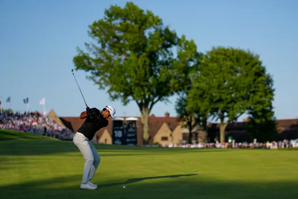 Aaron Rai, of England, hits his approach shot from the...