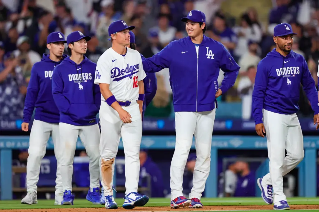 Dodgers star Shohei Ohtani, center, reacts with, from far left,...