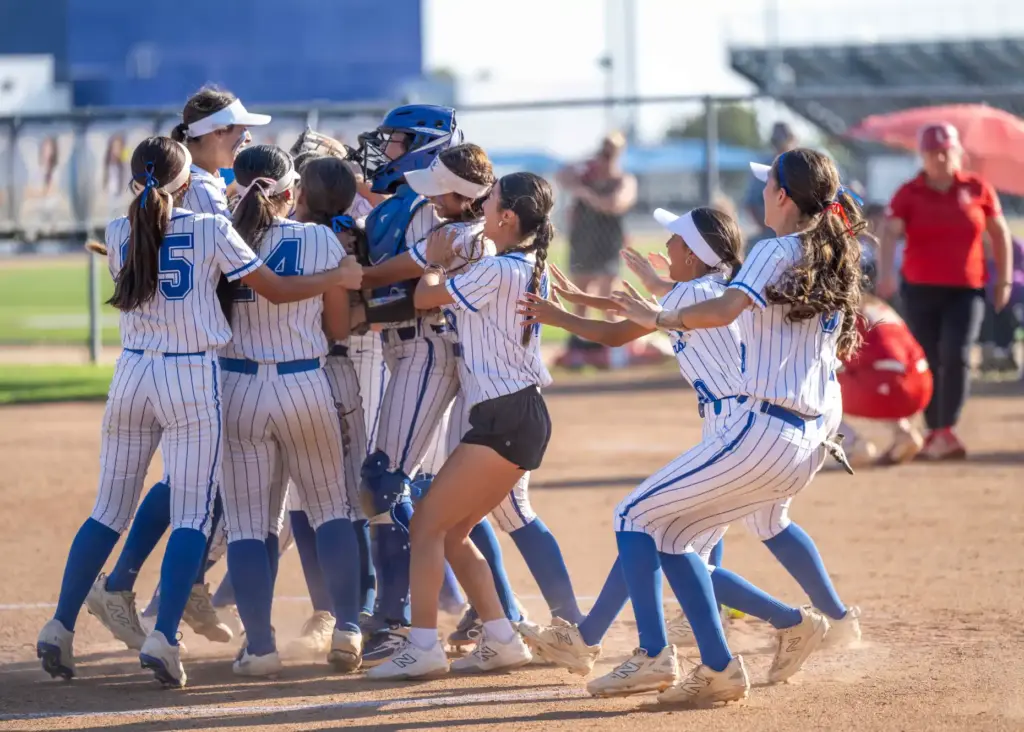 La Habra players celebrate their 11-8 victory over Orange Lutheran...