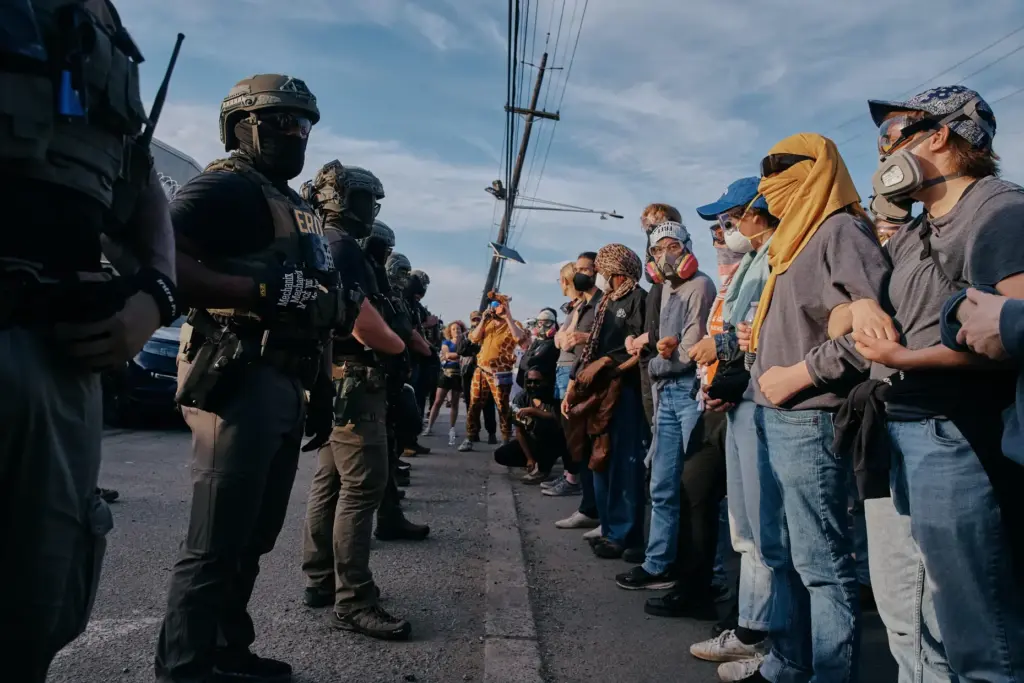 Protesters confront ICE agents outside the Delaney Hall detention center...