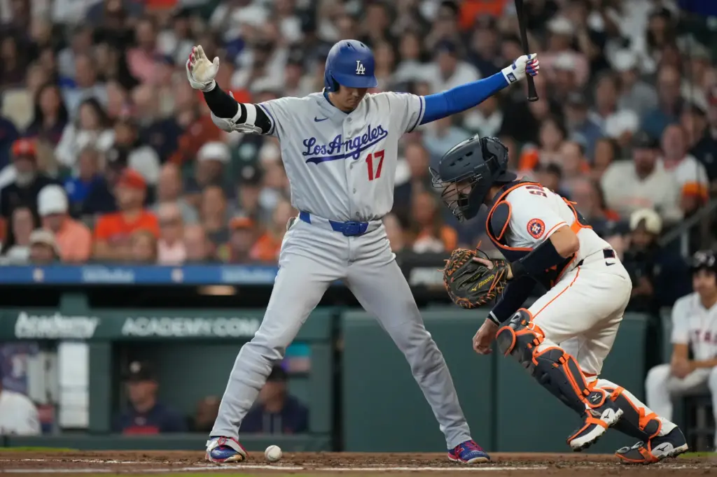 Dodgers star Shohei Ohtani watches as Houston Astros catcher Cesar...