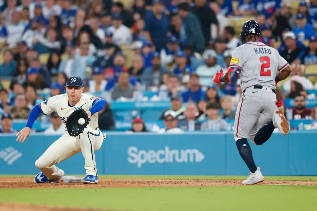 Dodgers first baseman Freddie Freeman, left, catches the ball at...
