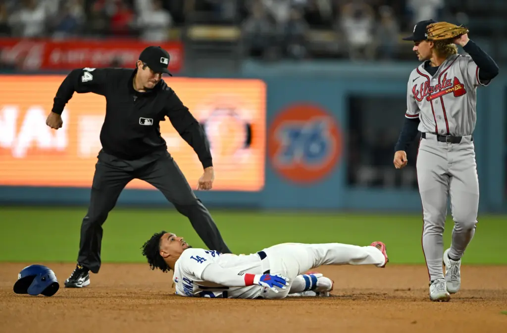 The Dodgers’ Santiago Espinal, bottom, is called out by the...