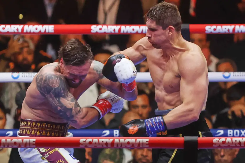 Oleksandr Usyk, left, fights during a boxing match against Rico...