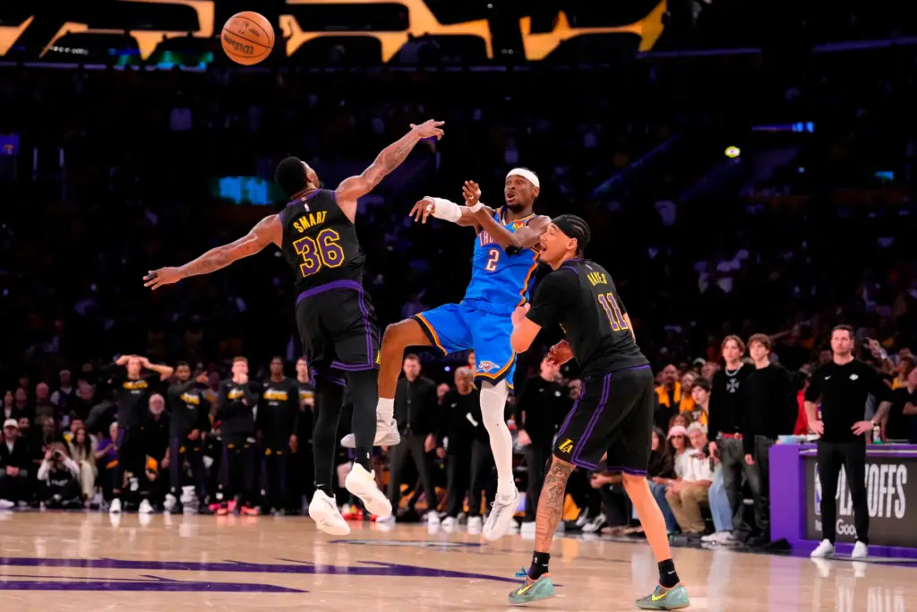 Oklahoma City Thunder guard Shai Gilgeous-Alexander, center, passes the ball...