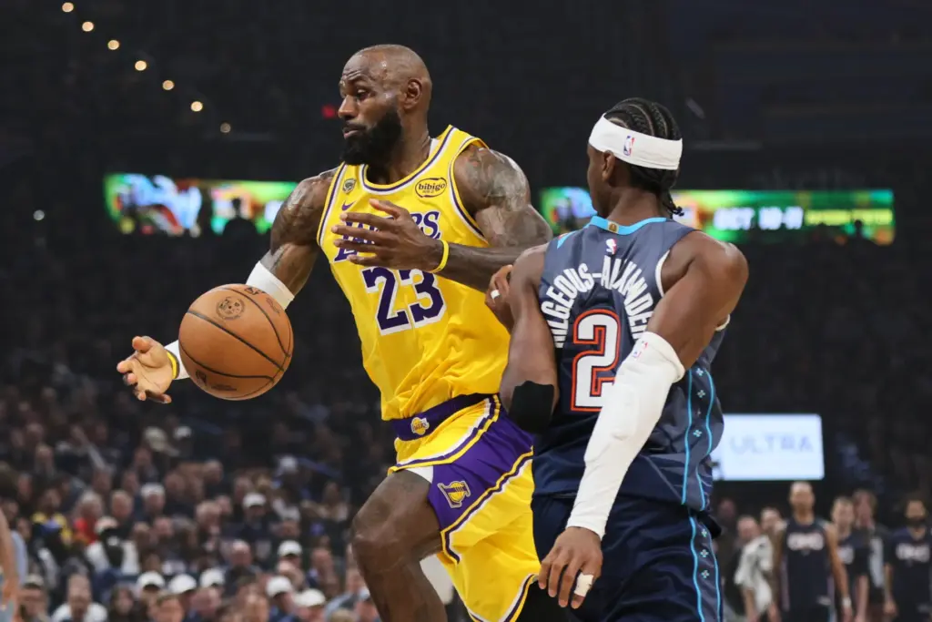 Lakers forward LeBron James, left, loses control of the ball...
