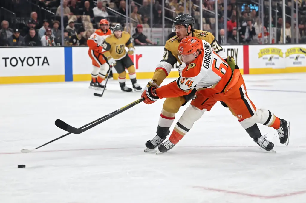 The Ducks’ Mikael Granlund, front, shoots the puck as the...