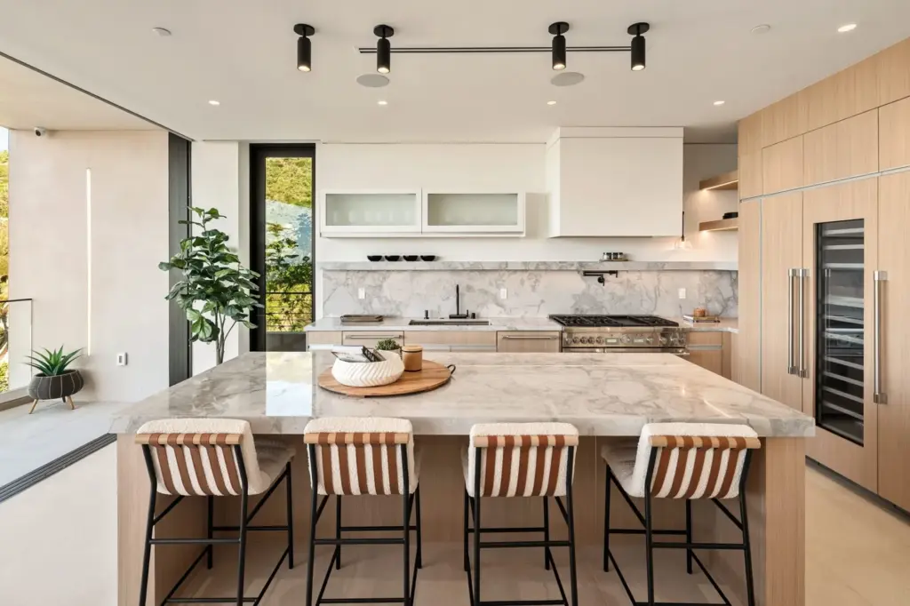 The space features a full-sized pantry a suite of Thermador...
