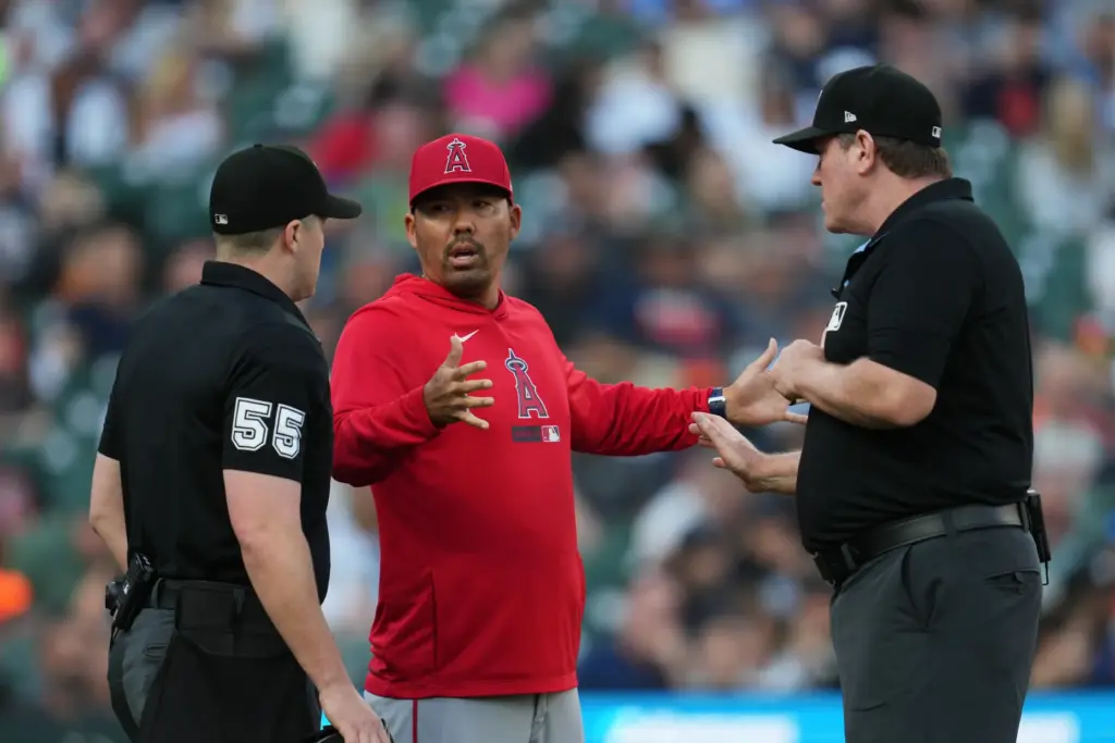 Angels manager Kurt Suzuki, center, argues a call with home...