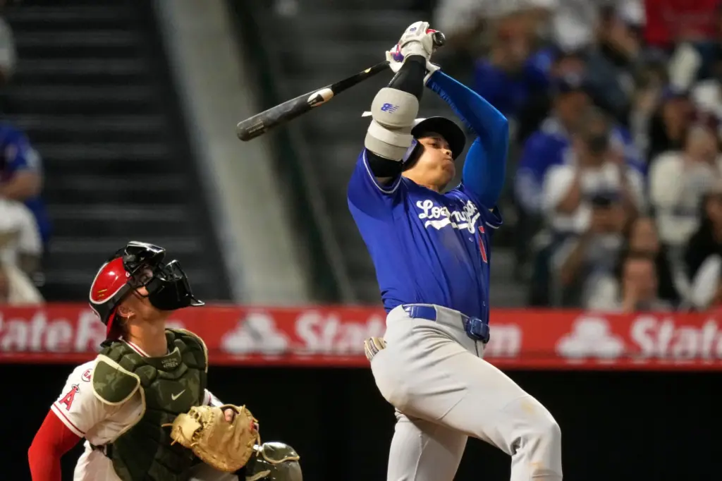 Dodgers’ Shohei Ohtani, right, hits an RBI double as Los...