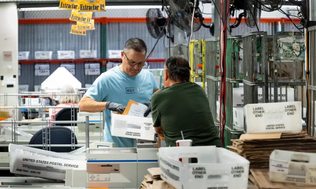 People work in sorting and extracting at the Orange County...