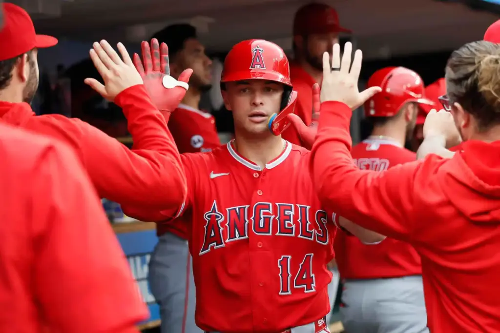 The Angels’ Logan O’Hoppe celebrates in the dugout after scoring...