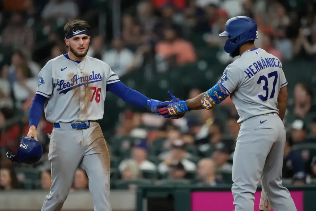 The Dodgers’ Alex Freeland, left, celebrates with teammate Teoscar HernÃ¡ndez...