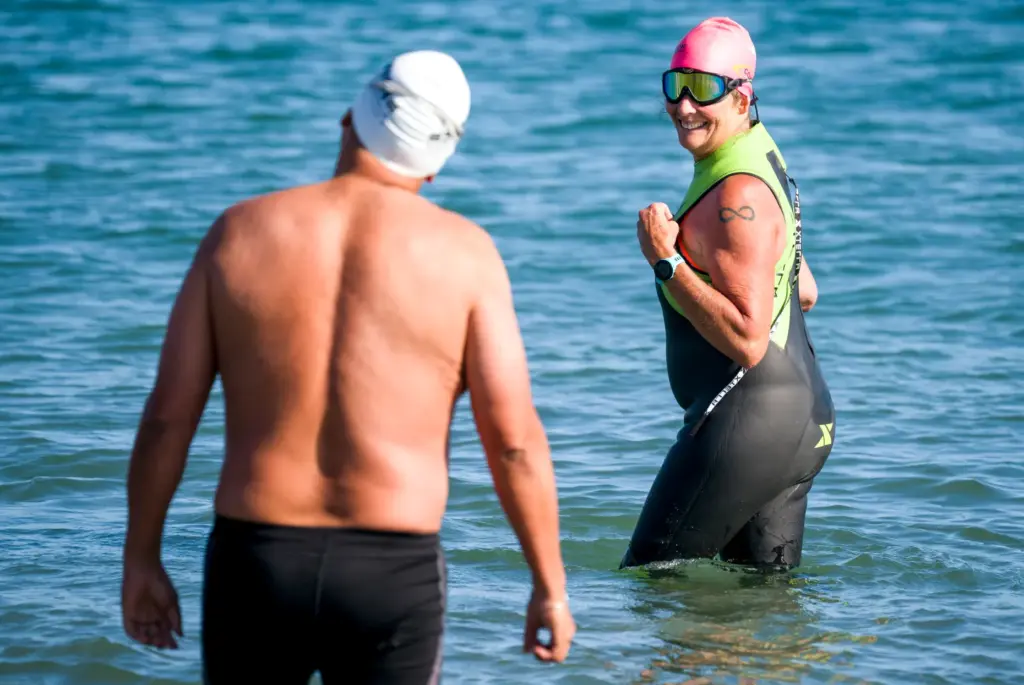 Maria Korcsmaros, right, looks back to fellow shark attack survivor,...