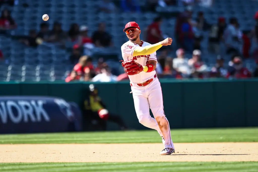 Angels third baseman Oswald Peraza throws to first base for...
