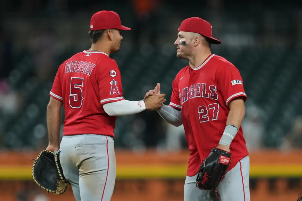Angels third baseman Vaughn Grissom, left, celebrates with center fielder...