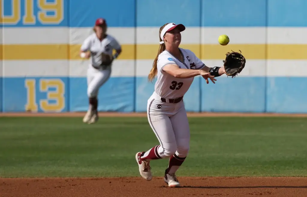 South Carolinaâs Karley Shelton (33) tosses the ball to first...