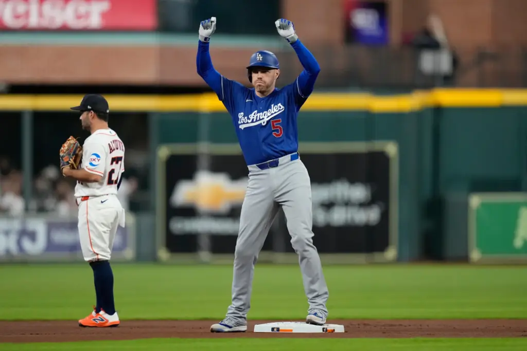 The Dodgers’ Freddie Freeman celebrates at second base after hitting...