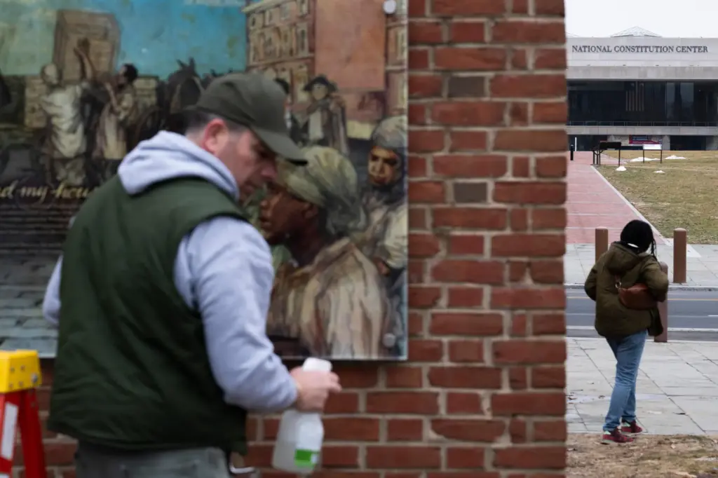 Panels that were part of an exhibit on slavery at the President’s House Site in Philadelphia are put back