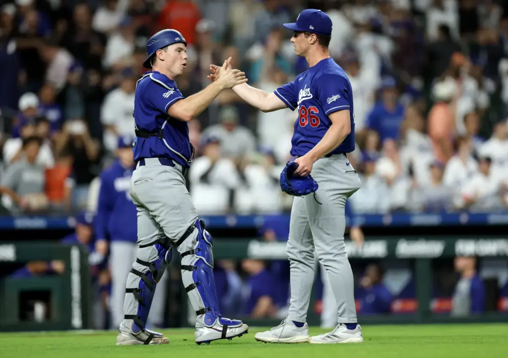 Dodgers catcher Will Smith, left, celebrates with relief pitcher Jack...